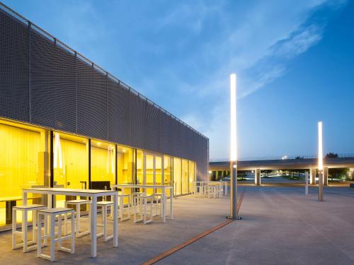 a group of tables and chairs in front of a building at Starling Hotel Lausanne in Lausanne