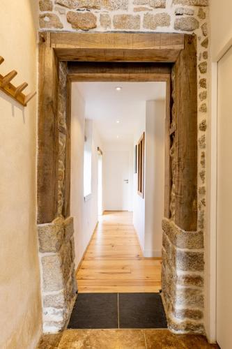 an open hallway with stone walls and wooden floors at Gîtes de Lézinadou - 8 personnes - Plomeur La Torche in Plomeur