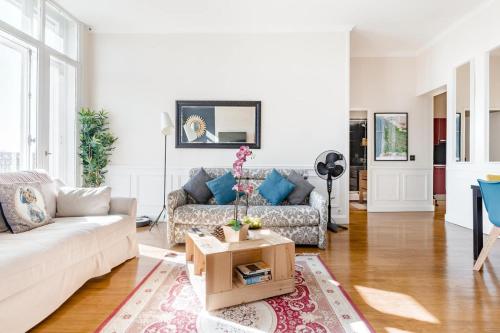 a living room with a couch and a table at Elegant apartment in Bordeaux at Les Chartrons in Bordeaux
