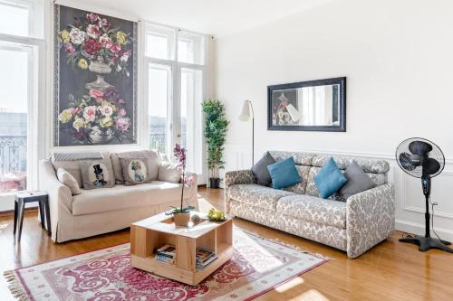a living room with a couch and a table at Elegant apartment in Bordeaux at Les Chartrons in Bordeaux