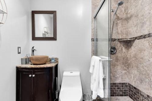 a bathroom with a shower and a toilet and a sink at Serene Poolside Getaway in Miami Gardens