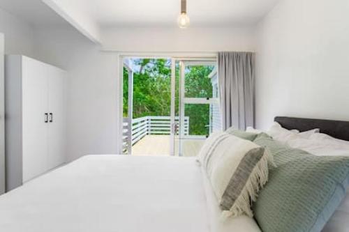 A bed or beds in a room at Cockle Bay Getaway is close to beach