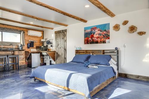 a bedroom with a bed and a kitchen at Cozy Parowan Studio 12 Mi to Brian Head Resort! in Parowan