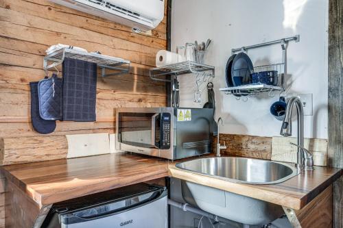 a kitchen with a sink and a microwave at Cozy Parowan Studio 12 Mi to Brian Head Resort! in Parowan