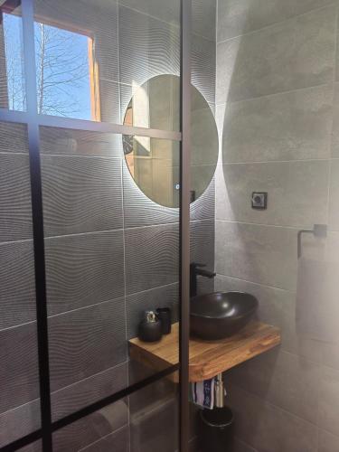 a bathroom with a sink and a mirror at Vikendica Nina 2 in Zlatibor