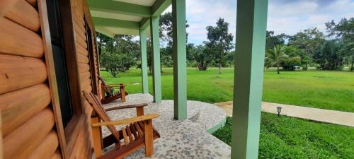 a porch of a house with two wooden benches at Mahogany Villas in Punta Gorda