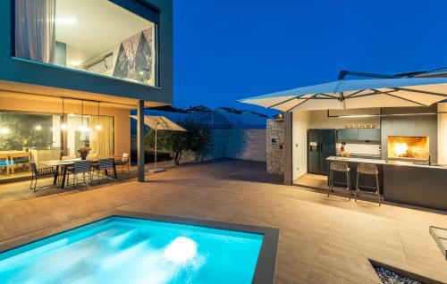 a house with a swimming pool and a kitchen at Dianas Garden Design Villa in Umag