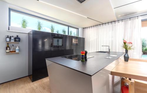a kitchen with a black and white counter top at Dianas Garden Design Villa in Umag