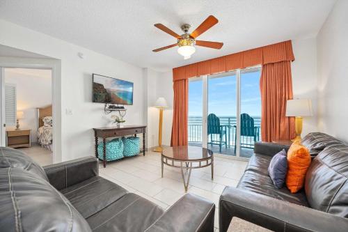 a living room with a couch and a ceiling fan at Luxury 10th Floor 2 BR Condo Direct Oceanfront Wyndham Ocean Walk Resort Daytona Beach | 1027 in Daytona Beach