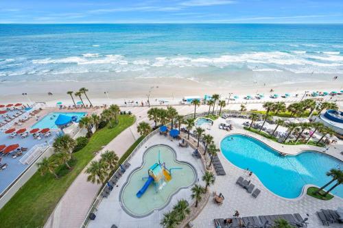 an aerial view of the beach and pools at a resort at Luxury 10th Floor 2 BR Condo Direct Oceanfront Wyndham Ocean Walk Resort Daytona Beach | 1027 in Daytona Beach