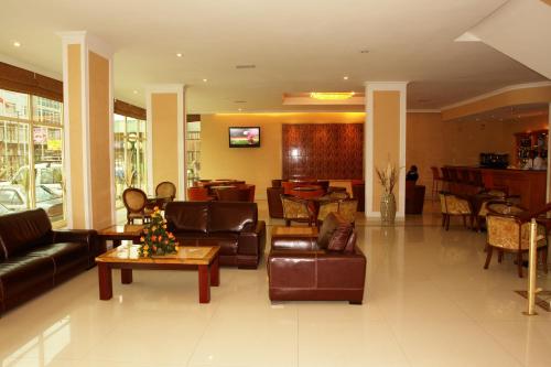 a living room with leather furniture and a lobby at Dreamliner Hotel in Addis Ababa