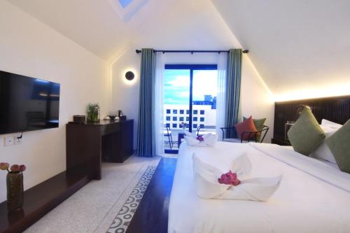 a hotel room with a bed with a flower on it at Aborest Tropical Hostel in Siem Reap