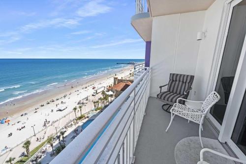 a balcony with a chair and a view of the beach at Luxury 12th Floor 2 BR Condo Direct Oceanfront Wyndham Ocean Walk Resort Daytona Beach | 1201 in Daytona Beach