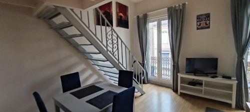 un salon avec un escalier et une télévision dans l'établissement Apartment Bordeaux Bègles, à Bègles