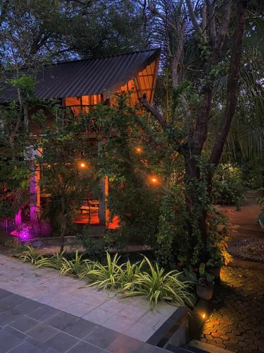 a house with lights in front of it at Levona Garden Resort in Habarana
