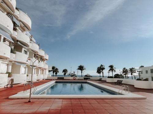 a swimming pool in the middle of a building at Femina Blue in Cambrils