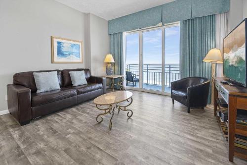 a living room with a couch and a table at Penthouse 19th Floor Resort Oasis Ocean Villa in Daytona Beach