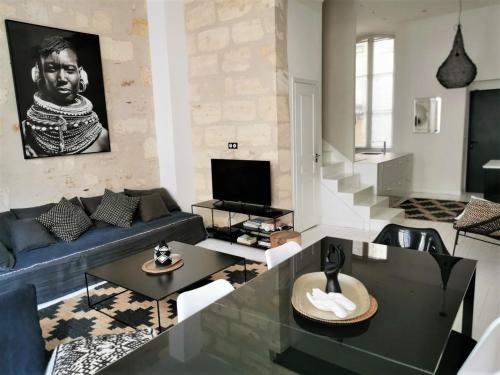 a living room with a couch and a table at Very nice apartment Bordeaux historical center in Bordeaux