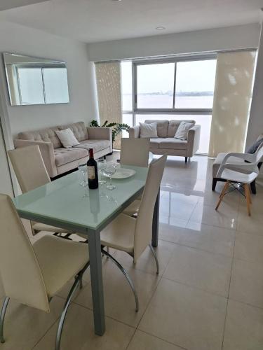 a living room with a table with a bottle of wine at Room with a view in Guayaquil