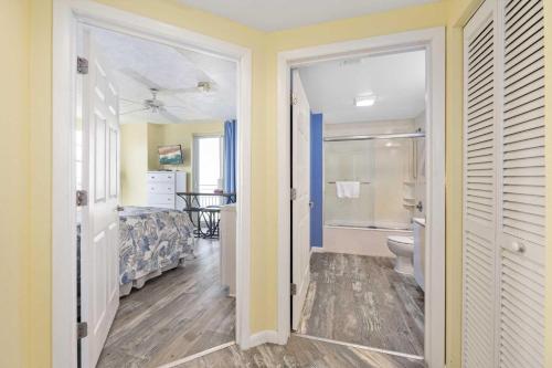 a bathroom with a bed and a toilet in a room at Luxury 6th Floor 2 BR Condo Direct Oceanfront Wyndham Ocean Walk Resort Daytona Beach | 601 in Daytona Beach