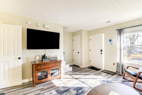 a living room with a flat screen tv on the wall at Bowling Green Townhome 4 Mi to Lost River Cave! in Bowling Green