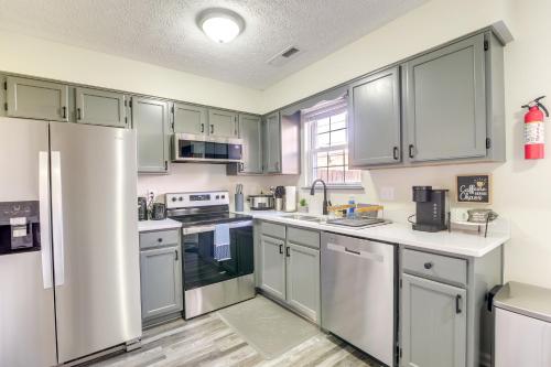 a kitchen with stainless steel appliances and gray cabinets at Bowling Green Townhome 4 Mi to Lost River Cave! in Bowling Green