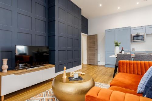 a living room with a couch and a table at Tower House Apartments in Bournemouth