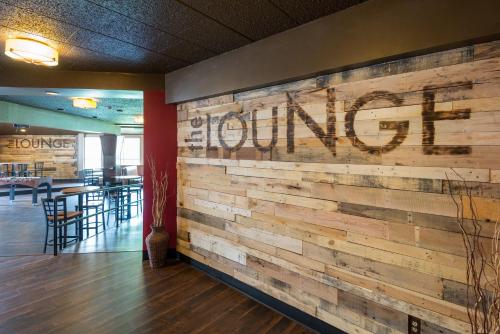 a wooden wall with a restaurant sign on it at Baymont by Wyndham Bartonsville Poconos in Bartonsville
