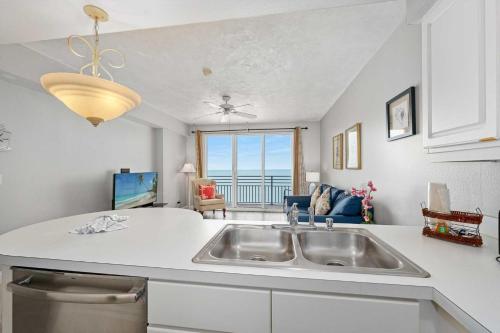 a kitchen with a sink and a view of the ocean at Luxury 11th Floor 1 BR Condo Direct Oceanfront Wyndham Ocean Walk Resort Daytona Beach | 1107 in Daytona Beach
