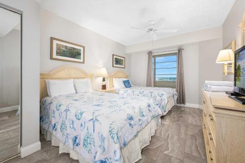 a bedroom with two beds and a television in it at Luxury 11th Floor 1 BR Condo Direct Oceanfront Wyndham Ocean Walk Resort Daytona Beach | 1107 in Daytona Beach