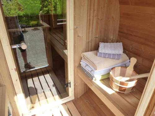 an inside view of a sauna with a door open at Ferienhaus mit Kamin , Terrasse und Aussensauna in Pöhla
