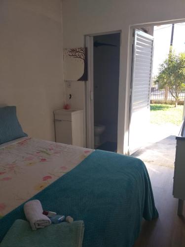 a bedroom with a bed with a stuffed animal on it at Kitnet espaçosa e bem localizada - Próximo ao lago e centro de eventos in Cascavel