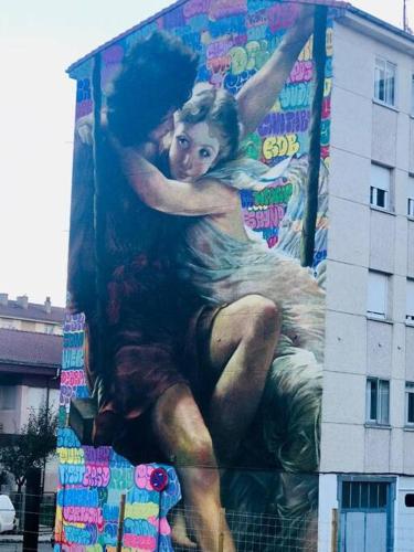 a painting of a woman on the side of a building at Apartament 3 Bedrooms 80m2 Alto Campoo Reinosa Cantabria in Reinosa