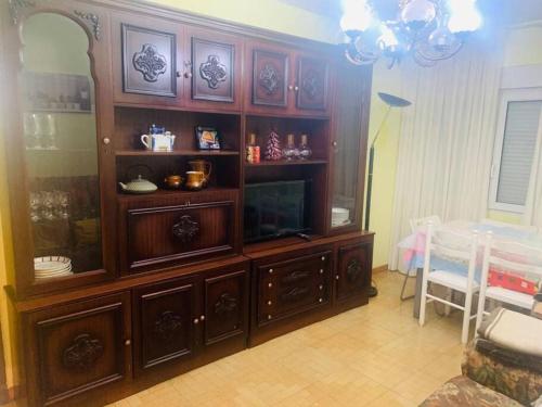 a large wooden entertainment center in a living room at Apartament 3 Bedrooms 80m2 Alto Campoo Reinosa Cantabria in Reinosa