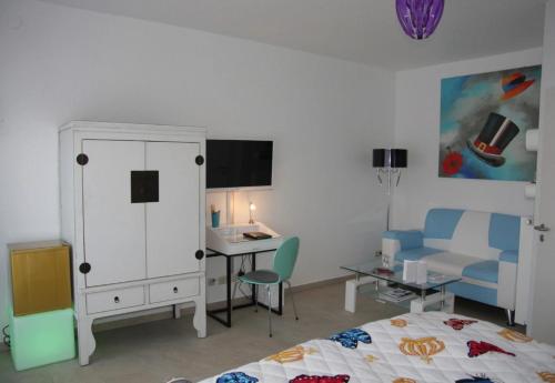 a bedroom with a bed and a desk and a cabinet at Gäste-Zimmer am Elberadweg in Damnatz