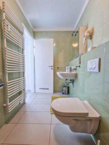 a bathroom with a toilet and a sink at Vila Novak in Novalja