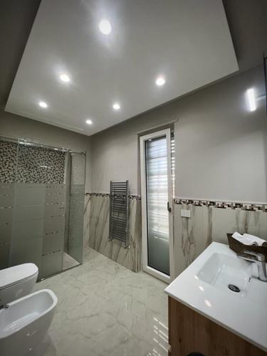 a bathroom with a sink and a toilet and a shower at Villa Abenante Pompei in Scafati