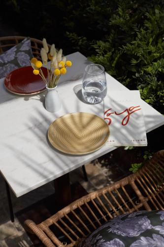 a table with a plate and a glass on it at Manto Hotel Lima - MGallery Collection in Lima