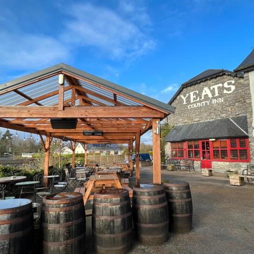 a group of barrels sitting in front of a building at The Yeats County Inn Hotel in Tobercurry