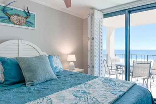 a bedroom with a bed with a view of the ocean at Phoenix East II 2044 in Orange Beach