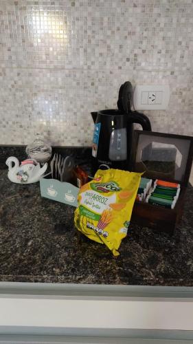 a kitchen counter with a bag of chips and a coffee maker at Wine&Sun in Gobernador Benegas