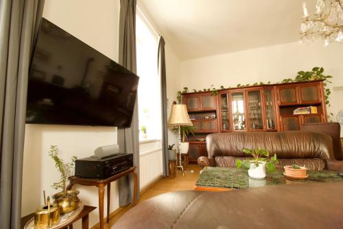 a living room with a couch and a flat screen tv at Villa Haag in Haag