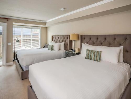 a bedroom with two beds and a window at Cannon Beach Hotel Collection in Cannon Beach