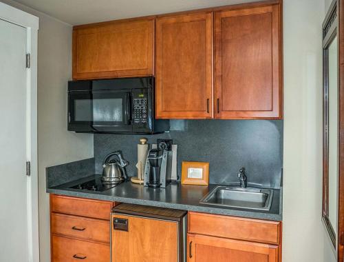 a kitchen with a sink and a microwave at Cannon Beach Hotel Collection in Cannon Beach