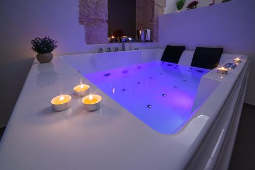 a bath tub with candles in a room with at LE PUGLIE LUXURY APARTMENTS in Molfetta