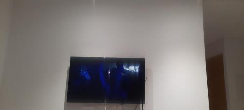 TV de pantalla plana en la parte superior de una pared en Room only for girls, uniquement pour fille en La Goulette