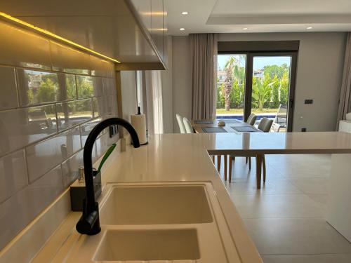 a kitchen with a sink and a counter top at Nirvana Belek Villas in Belek