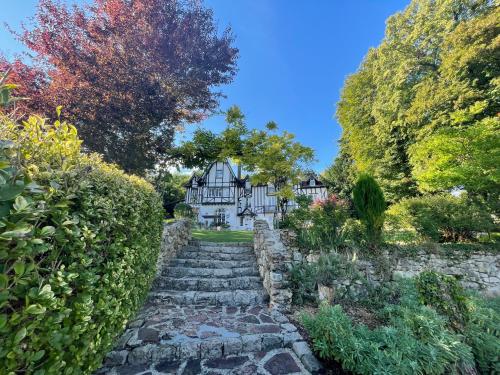 an estate with a stone path leading to a house at Le Manoir de Sainte-Aulde in Sainte-Aulde