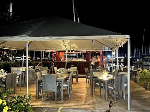 un ristorante con tavoli e sedie sotto una tenda di Waterfront Villa South Finger 227 Jolly Harbour a Jolly Harbour