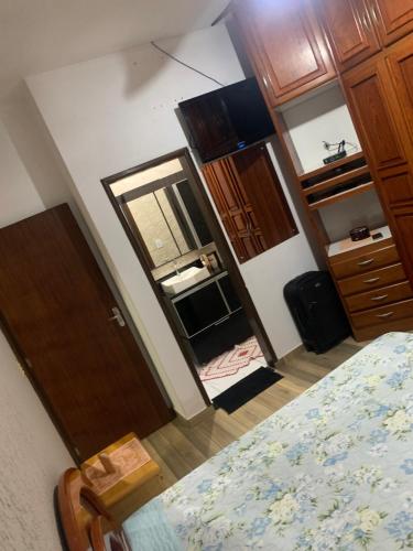 a bedroom with a bed and a mirror and a door at Casa Grande in Imbituba